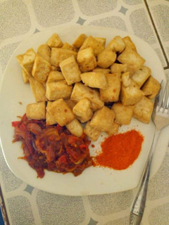 A picture of Fried yam with sauce and dry red pepper.