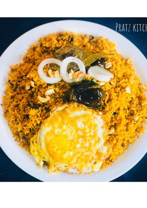 A picture of Eggplant rice with half boiled omelette.