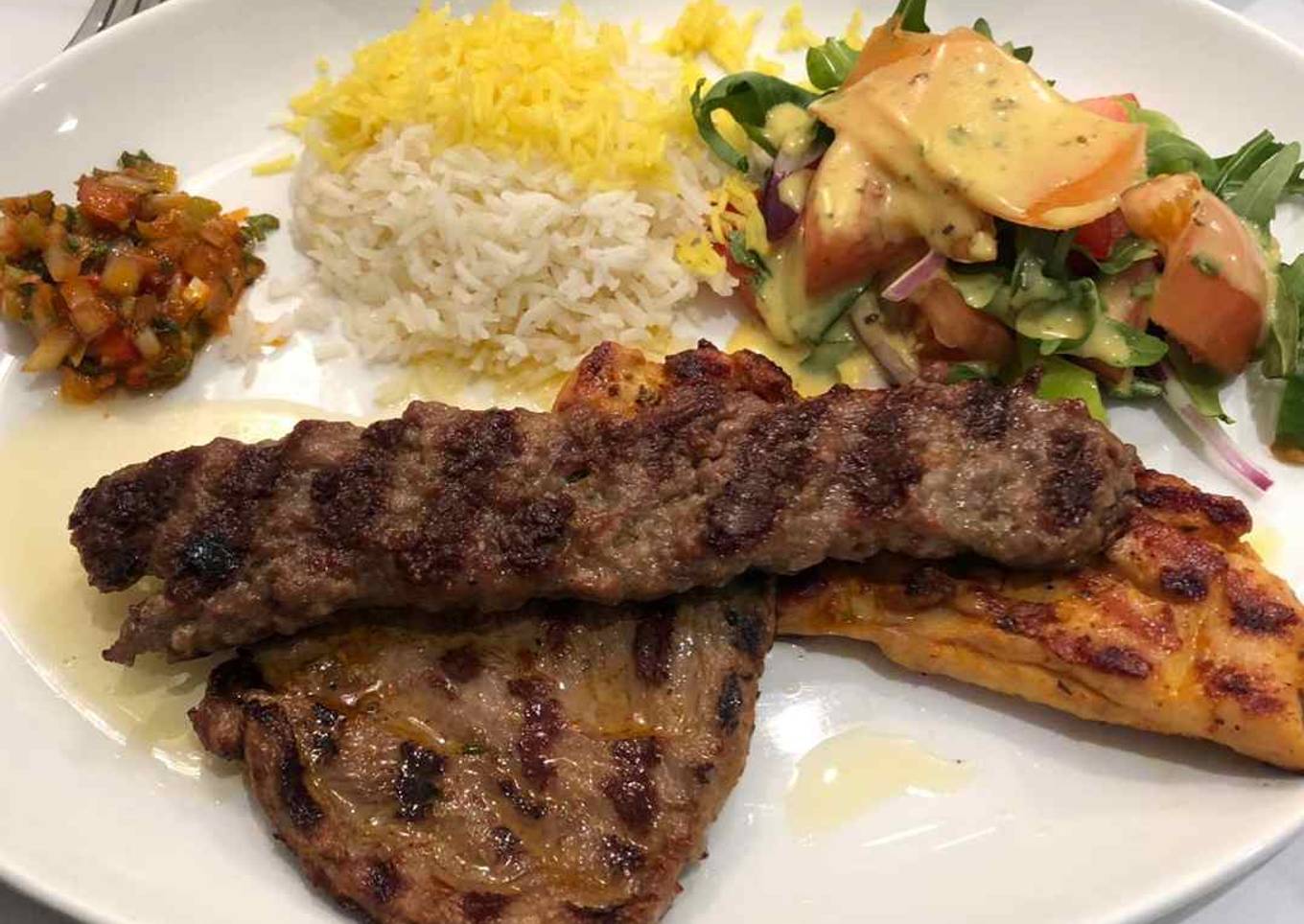 Rice with grilled meat with stew and salad