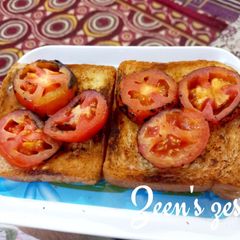 A picture of Garlic Bread Toast with Roasted Tomatoes.