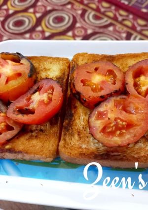 A picture of Garlic Bread Toast with Roasted Tomatoes.