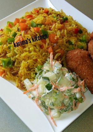 A picture of Fried rice and chicken.