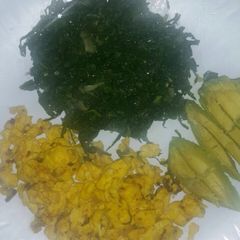 A picture of Fried eggs with ugali and skuma.