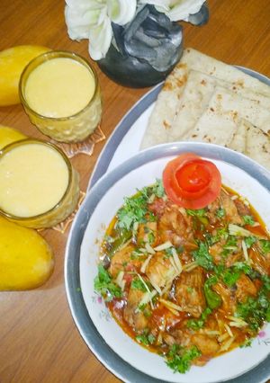 A picture of Chicken Karahi with chapati and mango shake.