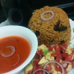 A picture of Pilau with spicy tomato soup.