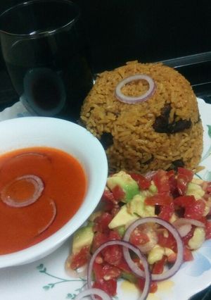A picture of Pilau with spicy tomato soup.