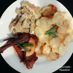 A picture of Chips with egg & roasted chicken.