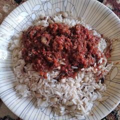A picture of Rice with beans and stew.