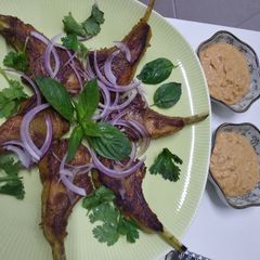 A picture of Lamb cutlets with satay sauce.