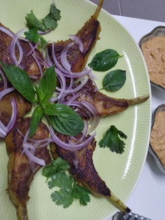 A picture of Lamb cutlets with satay sauce.