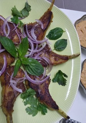 A picture of Lamb cutlets with satay sauce.
