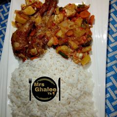 A picture of White rice with chicken cabbage sauce.