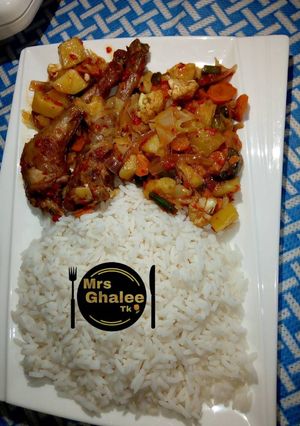 A picture of White rice with chicken cabbage sauce.