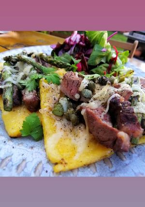A picture of Open steak polenta sandwich with asparagus and horseradish.