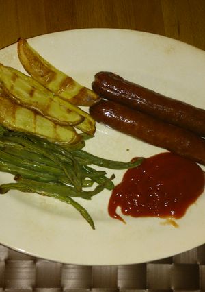 A picture of Baked Sausages with potatoes and beans.