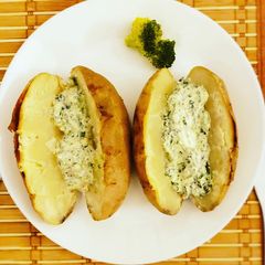 A picture of Baked potatoes and creamy cheese spinach dip.