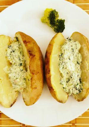 A picture of Baked potatoes and creamy cheese spinach dip.