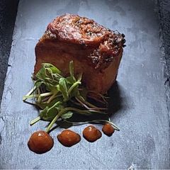 A picture of Pork loin with chorizo and tomato topping.