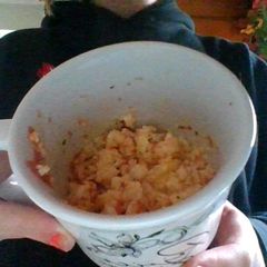 A picture of Scrambled eggs in a cup.