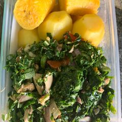 A picture of Green vegetable with boiled Irish and plantain.
