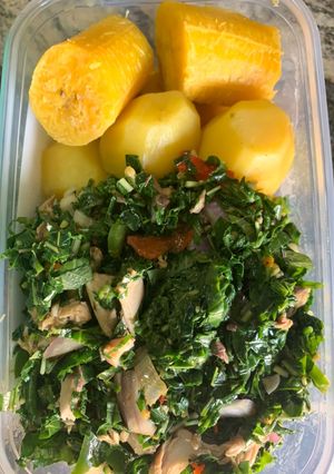 A picture of Green vegetable with boiled Irish and plantain.