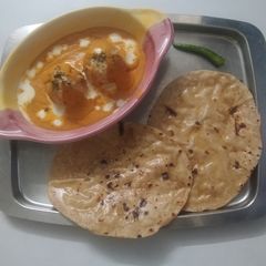 A picture of Malai Kofta in Orange🟠 Gravy.