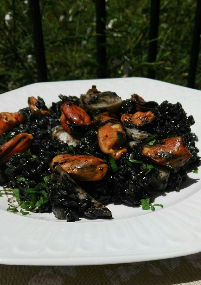Una foto de Arroz negro con sepia y mejillones