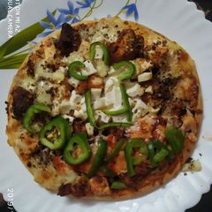 A picture of Pizza with edible cookpad hat.