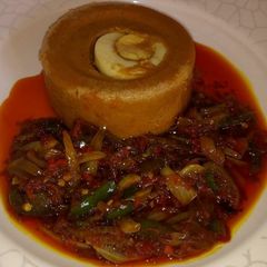 A picture of Moi moi with palm oil sauce.