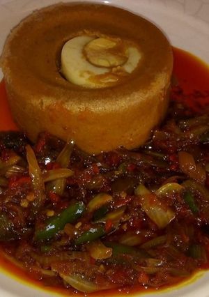 A picture of Moi moi with palm oil sauce.