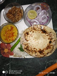 A picture of चने की रोटी दाल तडका के साथ.