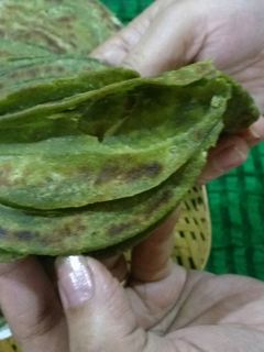 A picture of Hariyala laccha paratha (layered green flat bread).