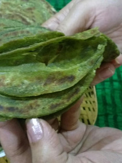 A picture of Hariyala laccha paratha (layered green flat bread).