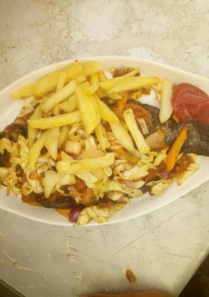 A picture of Tilapia fish serve with chip.