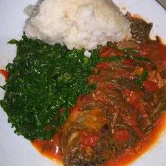 A picture of Wet fly fish with sukuma and ugali.