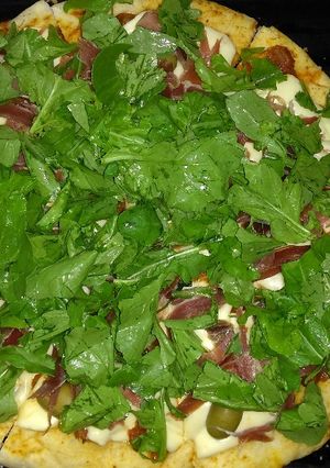 Una foto de Pizza de rúcula y jamón crudo