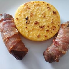 A picture of Pigs in blankets with fried polenta.