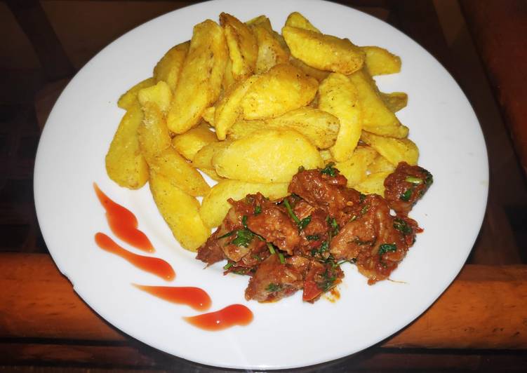 Potato wedges and fried goat meat