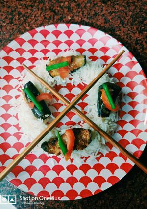 A picture of Brinjal sushi with rice.