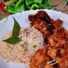 A picture of KFC chicken style with rice.