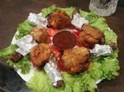 A picture of breaded chicken legs