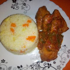 A picture of Carrot pineapple rice with wet fried chicken.