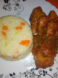 A picture of Carrot pineapple rice with wet fried chicken.