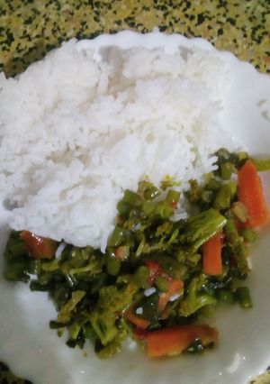 A picture of Fried vegetables served with rice.