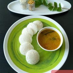 A picture of Idli with sambhar.