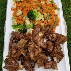 A picture of Black pepper mutton with stir fried veggies.