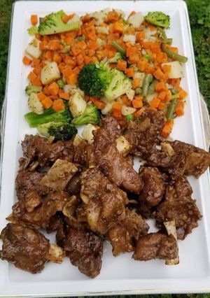 A picture of Black pepper mutton with stir fried veggies.