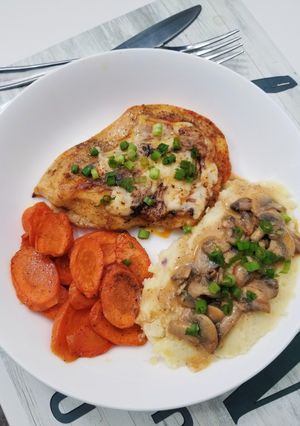 A picture of CHEESY MUSHROOM CHICKEN with mashed potatoes & roasted carrots.
