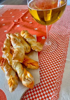 A picture of Puff Pastry Twists with 'Nduja Spread, Speck, and Ragusano Cheese.