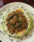 Pan Fried Spinach Hakka Noodles with Chilli Fish & Mushrooms Gravy- on the bed of poached Eggs